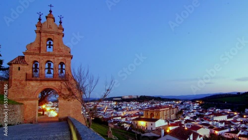 unique night to day timelapse church tower on a wide spectacular angle during a sunrise rural spanish andalucia sierra jamones old white villages of the Sierra de Aracena, Huelva Jabugo Spain photo