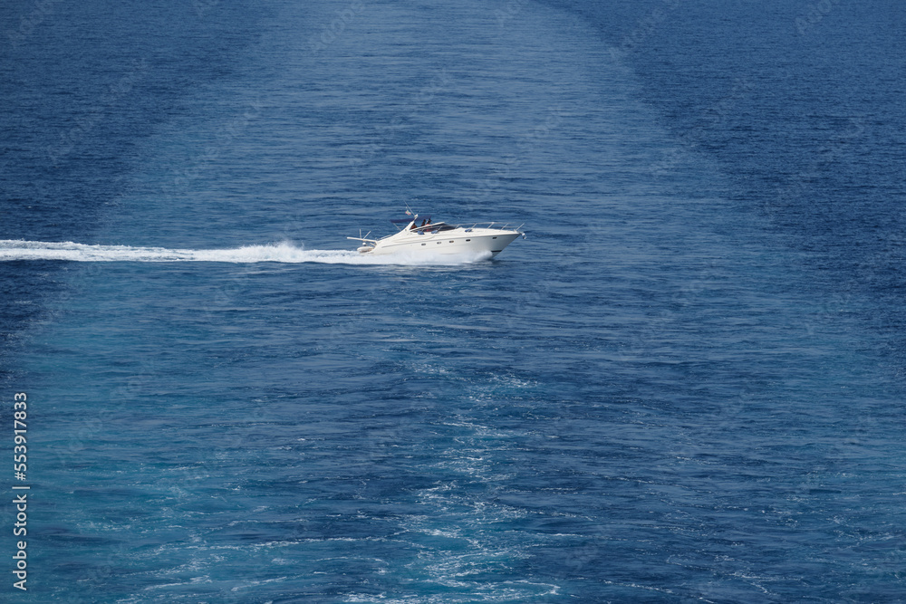 Big high speed boat fast movement on the water top view. Aerial view of the sea and the boat. Big high speed boat fast movement on the water top view. Aerial view of the sea and the boat.