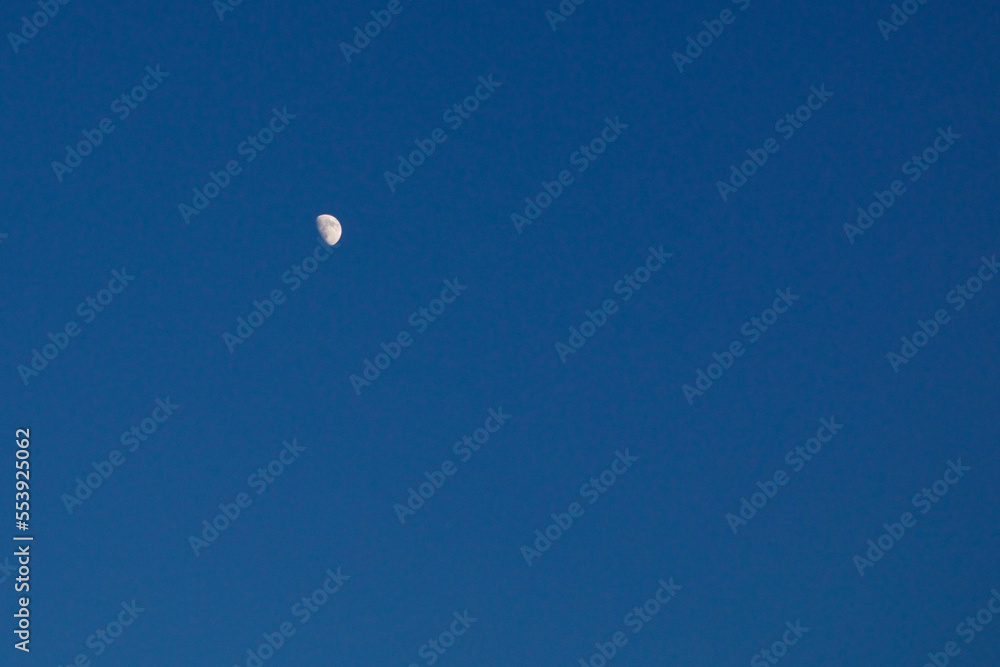 Little moon in the sky. Crescent moon against a bright sky.