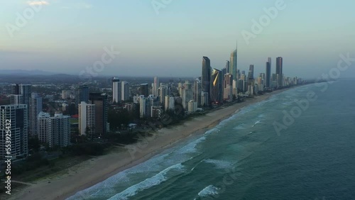 Aerial panning along the skyline capturing long stretched sandy beach of east coast Australia at sunset dusk, holiday resort precinct Broadbeach South, Gold Coast, Queensland. photo