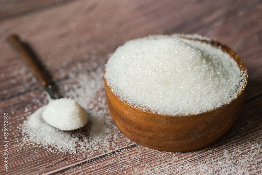 Sugar on spoon and wooden bowl, white sugar for food and sweets dessert candy heap of sweet sugar crystalline granulated Sugar on spoon and wooden bowl, white sugar for food and sweets dessert candy heap of sweet sugar crystalline granulated