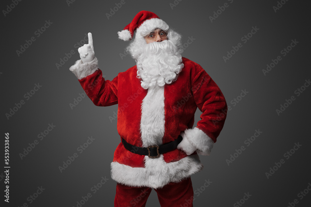 Portrait of old santa claus dressed in red suit pointing up. Portrait of old santa claus dressed in red suit pointing up.