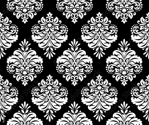 Wallpaper in the style of Baroque. Seamless vector background. White and black floral ornament. Graphic pattern for fabric, wallpaper, packaging. Ornate Damask flower ornament