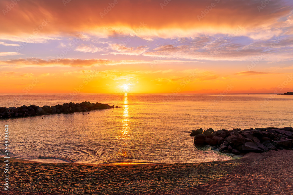 view at sunrise or sunset in sea with nice beach , surf , calm water and beautiful clouds on a background of a sea landscape view at sunrise or sunset in sea with nice beach , surf , calm water and beautiful clouds on a background of a sea landscape