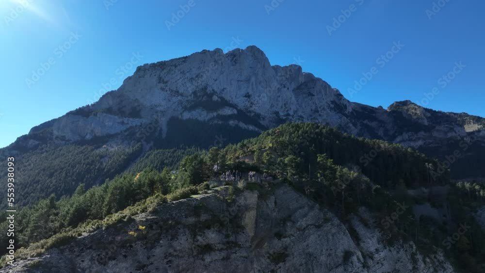 Aerial view rising over Pedroforca pine woodland towards majestic Pyrenees rocky mountain formation Aerial view rising over Pedroforca pine woodland towards majestic Pyrenees rocky mountain formation