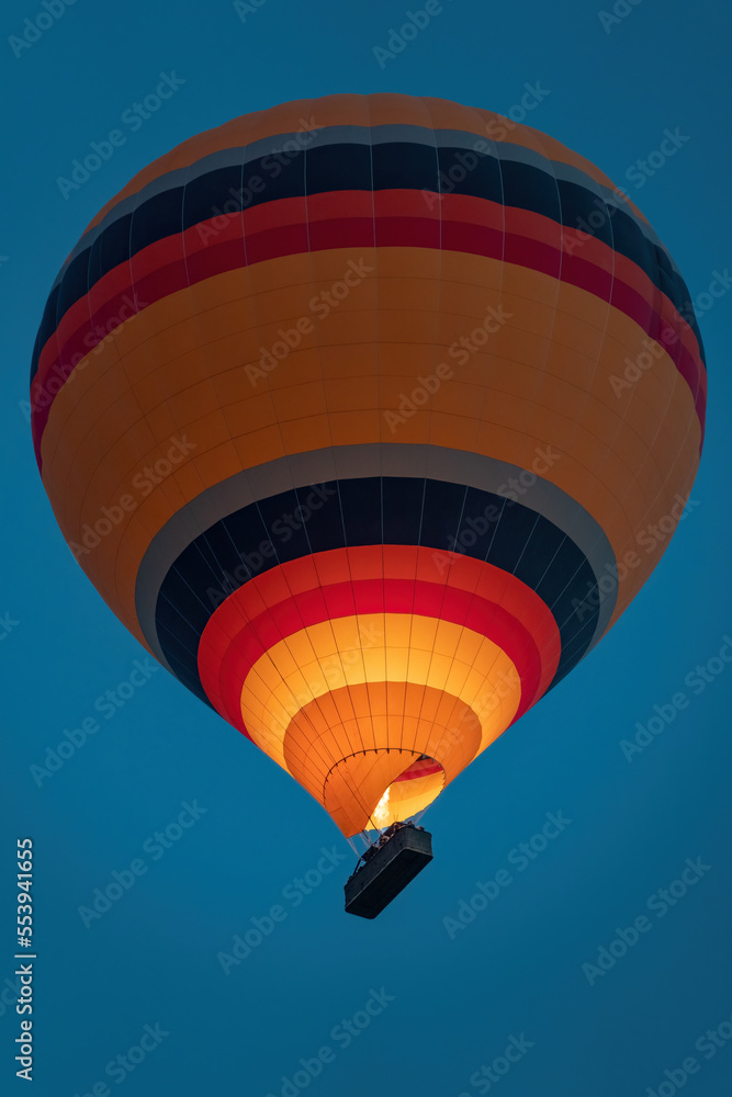 Fototapeta premium hot air balloon in the blue sky at sunrise