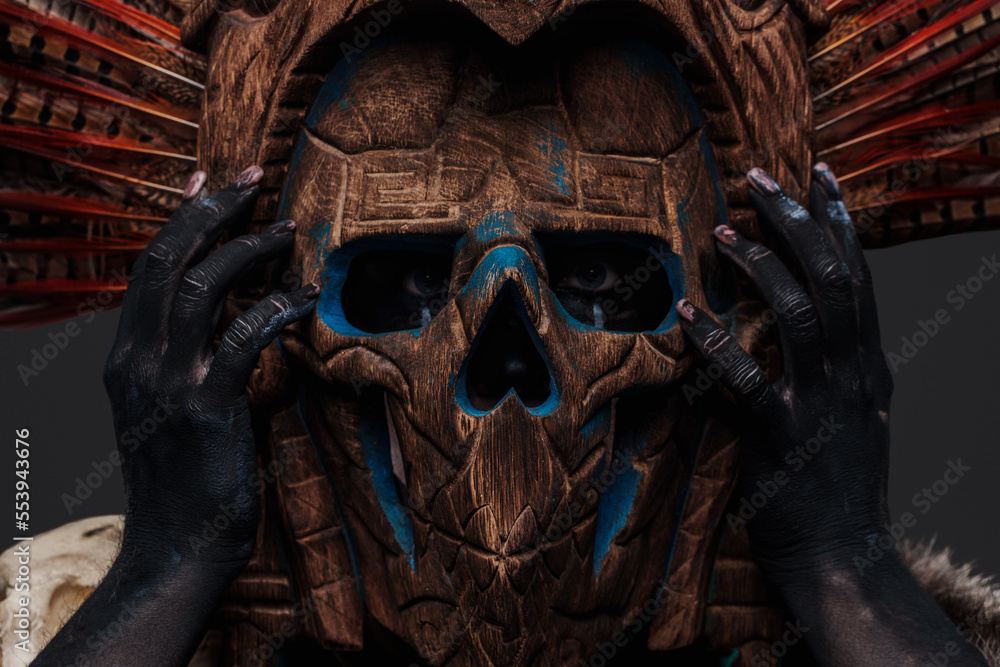 Headshot of isolated on grey aztec witch with mask looking at camera. Headshot of isolated on grey aztec witch with mask looking at camera.