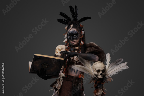Shot of grim ancient necromancer with staff and book of dead.