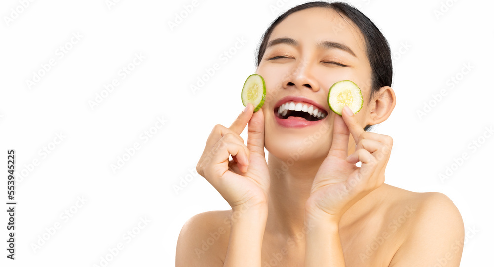 Happy smiling asian girl applying facial organic cucumber for healthy beauty spa treatment and self skin care lifestyle concept white background. Happy smiling asian girl applying facial organic cucumber for healthy beauty spa treatment and self skin care lifestyle concept white background.