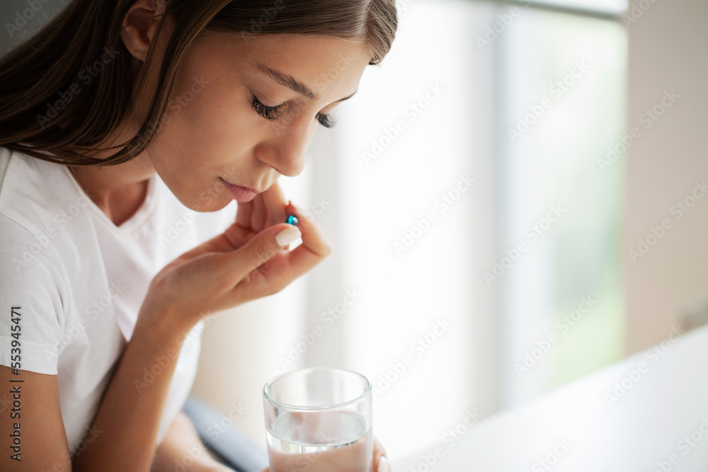 A young woman is suffering from a toothache in the office A young woman is suffering from a toothache in the office