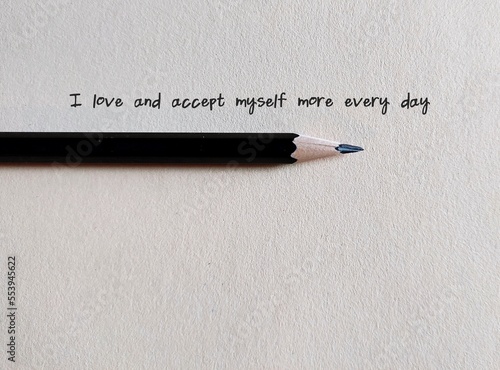 Fotografia Pencil writing on paper - I accept and love myself more every day - concept of s