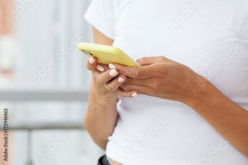 Attractive woman looking at smartphone screen, reading media news