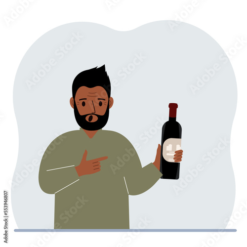 A man holds a bottle of alcohol or wine in his hand. Shock man suffering from severe alcohol addiction. Alcoholism abuse concept.