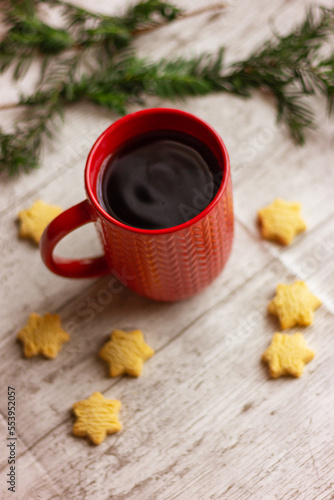 red cup with tea and cookies on the table  close-up. winter holidays  Christmas  New Year