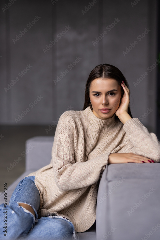 Happy young woman lying on couch and relaxing at home Happy young woman lying on couch and relaxing at home