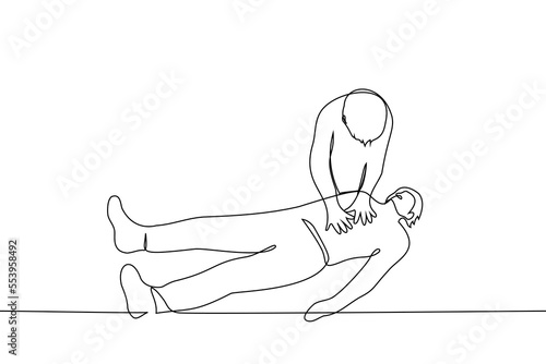 man makes a heart massage lying on the ground. paramedic first aid concept