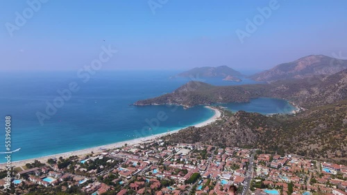 Drone back view of man on the rock, Oludeniz beach, shooting himself, beautiful view photo