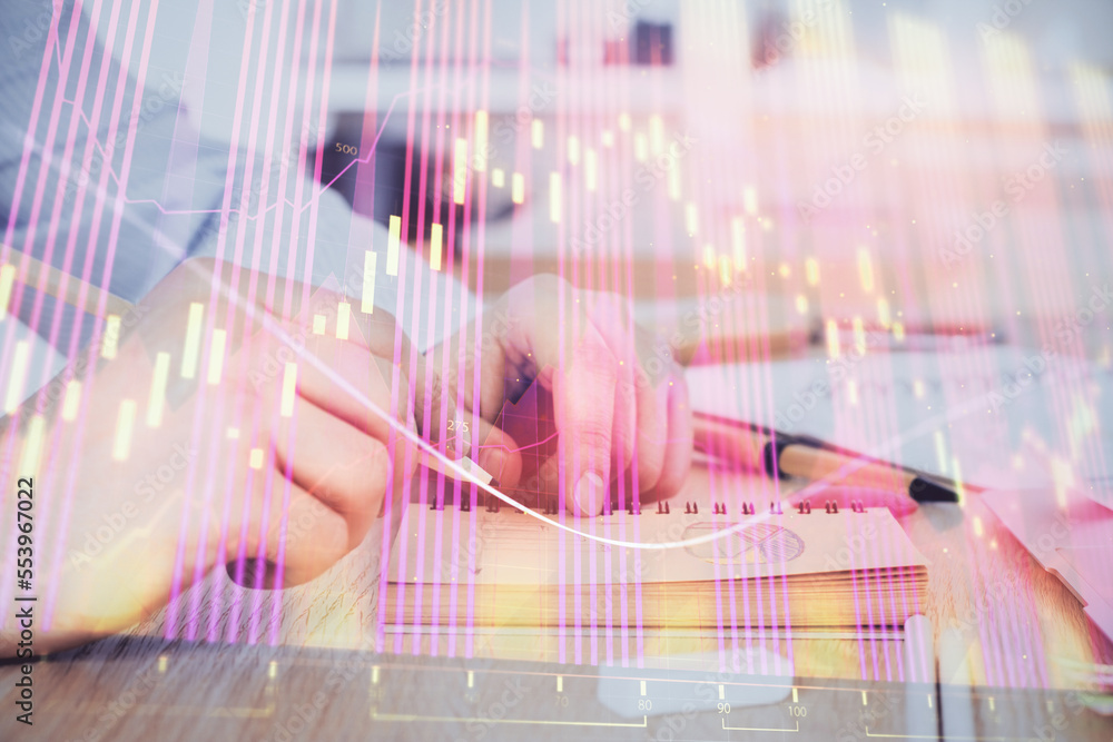 Multi exposure closeup hands with stock market forex graph.