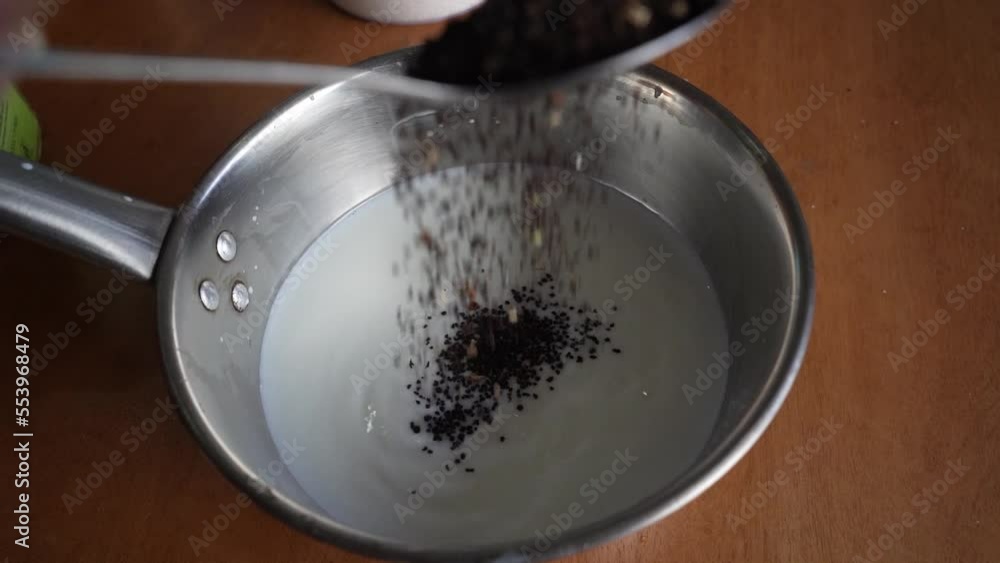 Pouring Raw Tea in Milk to Boil Pouring Raw Tea in Milk to Boil