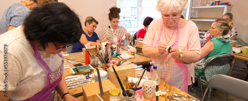 Women in art workshop making decoupage boxes