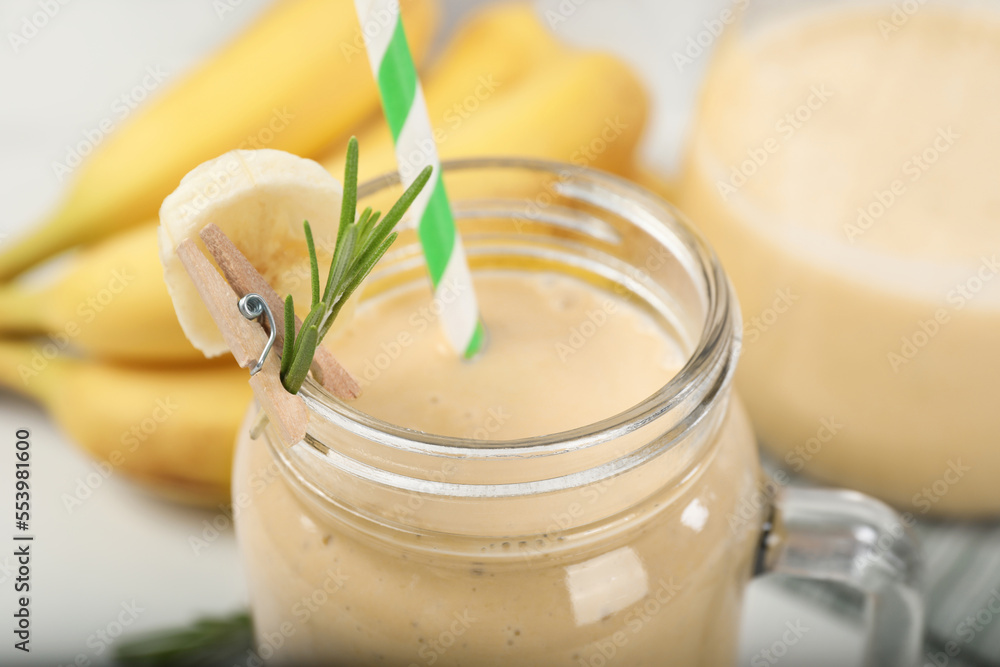 Mason jar of tasty banana smoothie with straw, closeup Mason jar of tasty banana smoothie with straw, closeup