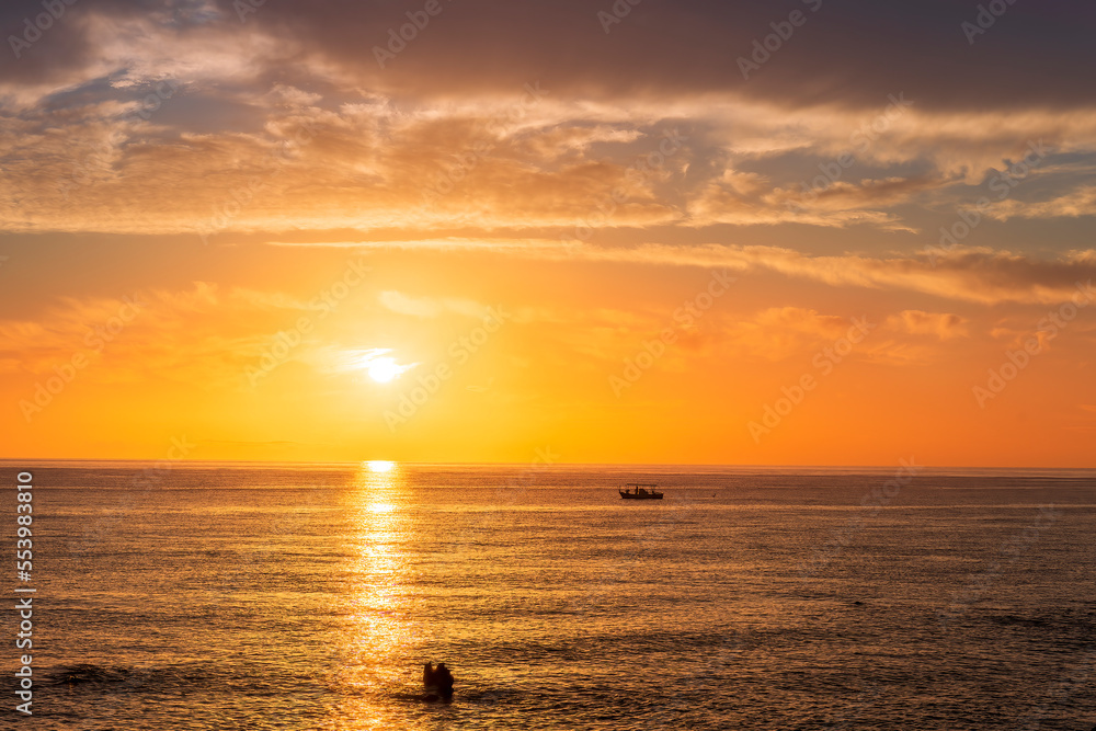 view at sunrise or sunset in sea with nice beach , surf , calm water and beautiful clouds on a background of a sea landscape