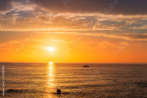 view at sunrise or sunset in sea with nice beach , surf , calm water and beautiful clouds on a background of a sea landscape © Yaroslav
