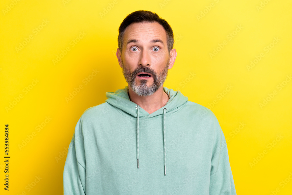 Portrait photo of retired mature age man grey beard open mouth speechless scared expensive product inflation isolated on yellow color background Portrait photo of retired mature age man grey beard open mouth speechless scared expensive product inflation isolated on yellow color background