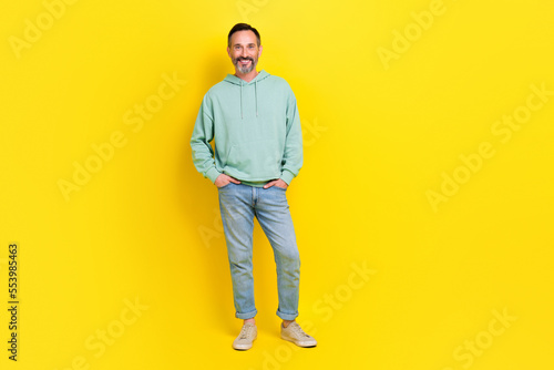 Full length photo of successful employer man hand pocket dressed comfort clothes stand empty space isolated on yellow color background