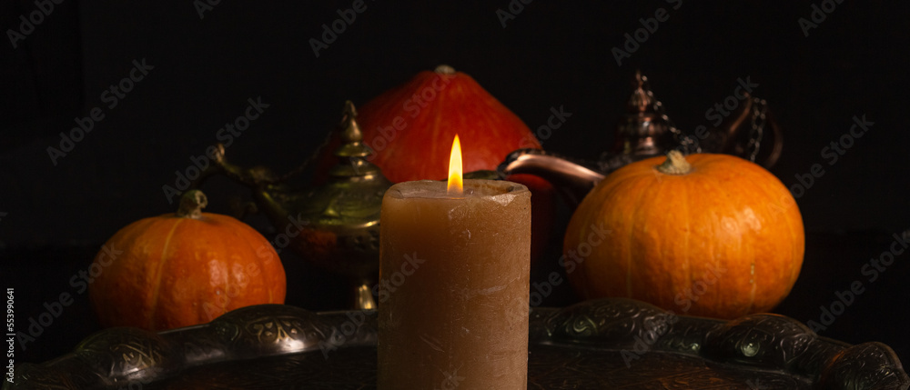 Yellow-orange pumpkins candle tray on a black background the concept of Halloween and the autumn harvest of pumpkin close-up copyspace from above Yellow-orange pumpkins candle tray on a black background the concept of Halloween and the autumn harvest of pumpkin close-up copyspace from above