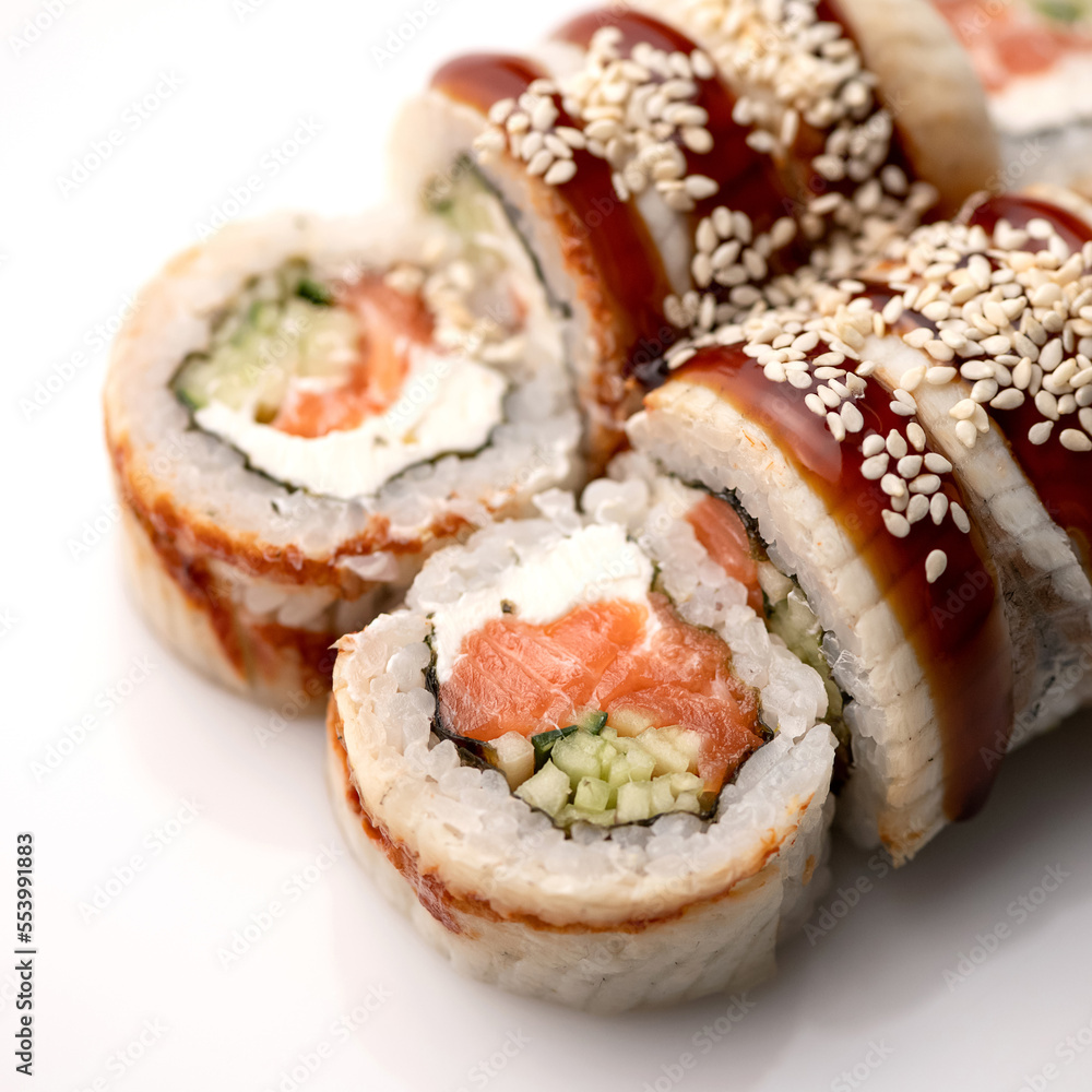 Sushi rolls with eel, cream cheese, salmon, cucumber. Healthy diet. Japanese cuisine. Isolate on white background. View from above. Serving dish. Soft focus. Close-up.