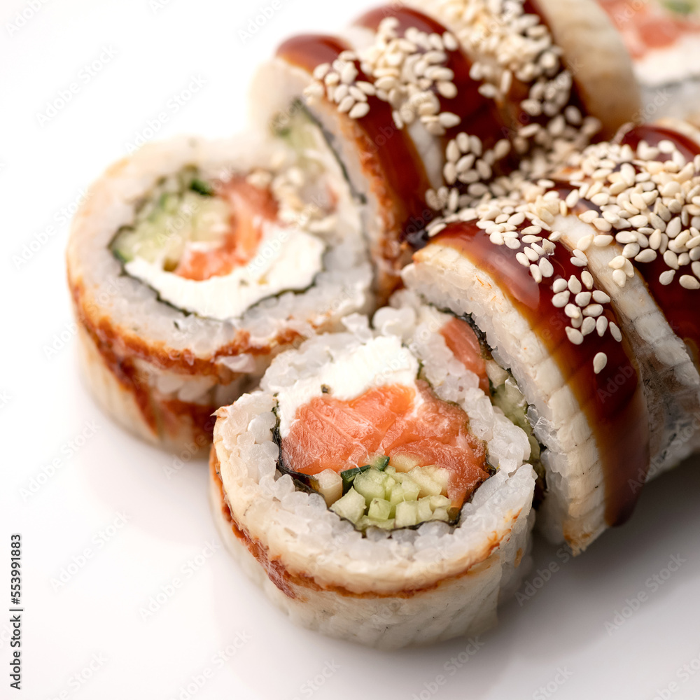 Sushi rolls with eel, cream cheese, salmon, cucumber. Healthy diet. Japanese cuisine. Isolate on white background. View from above. Serving dish. Soft focus. Close-up. Sushi rolls with eel, cream cheese, salmon, cucumber. Healthy diet. Japanese cuisine. Isolate on white background. View from above. Serving dish. Soft focus. Close-up.