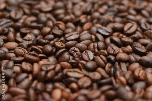 Detailed photo of coffee beans before being processed into a drink isolated on wood. Concept photo of the basic ingredients of coffee drinks.