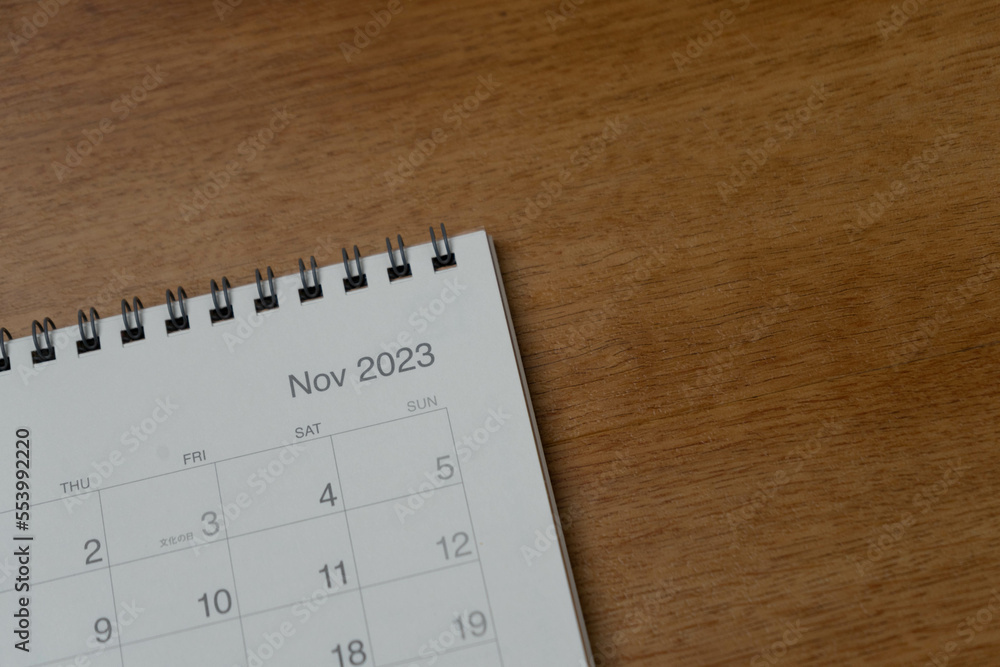 November 2023 calendar page on wood background. Calendar background for reminder, business planning, appointment meeting and event. November 2023 calendar page on wood background. Calendar background for reminder, business planning, appointment meeting and event.