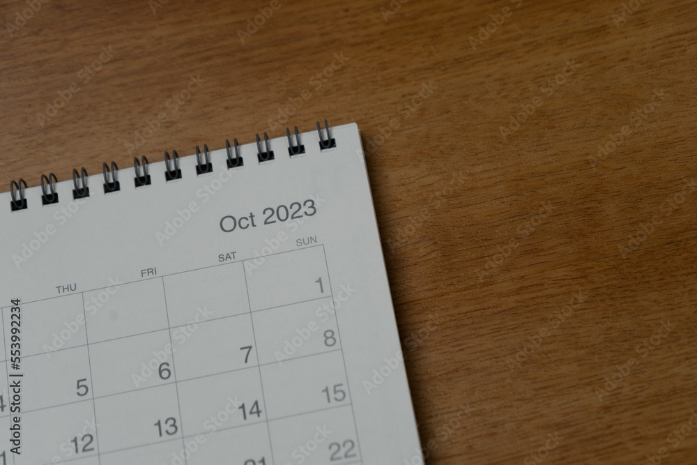 October 2023 calendar page on wood background. Calendar background for reminder, business planning, appointment meeting and event. October 2023 calendar page on wood background. Calendar background for reminder, business planning, appointment meeting and event.