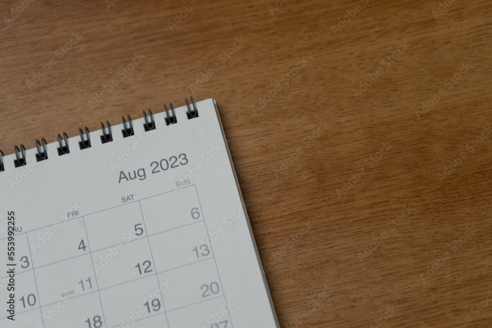 August 2023 calendar page on wood background. Calendar background for reminder, business planning, appointment meeting and event. August 2023 calendar page on wood background. Calendar background for reminder, business planning, appointment meeting and event.