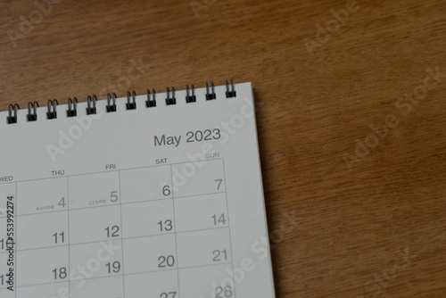 May 2023 calendar page on wood background. Calendar background for reminder  business planning  appointment meeting and event.