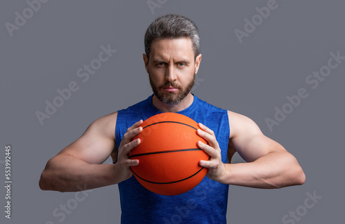 muscular athlete man basketball player with ball. athlete man basketball player in sportswear.