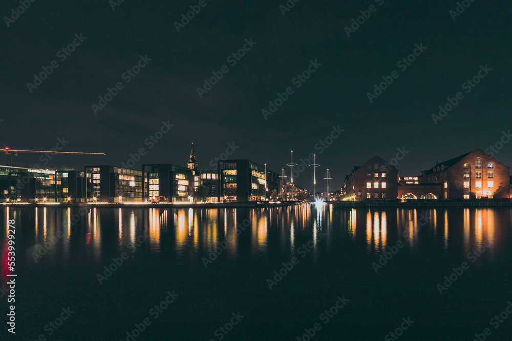 buildings by the water at night