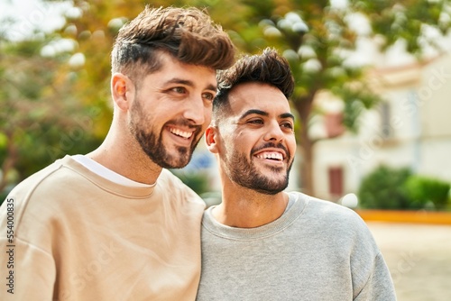 Young couple smiling confident hugging each other at park photo