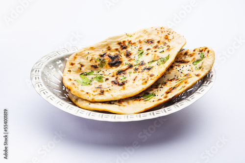 Tandoori naan, Indian Tandoori roti or flat bread served in a plate, isolated photo