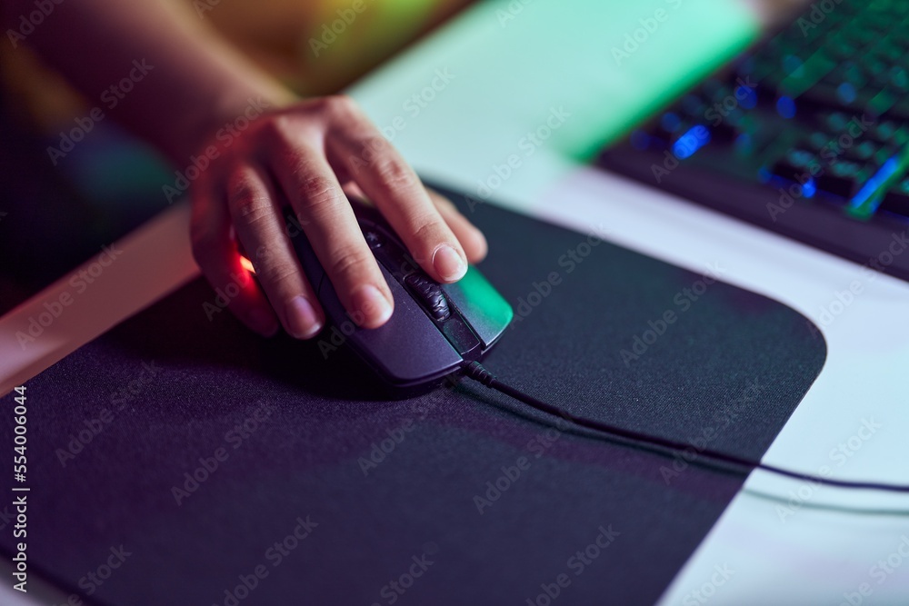 Young blonde woman using computer mouse at gaming room Young blonde woman using computer mouse at gaming room
