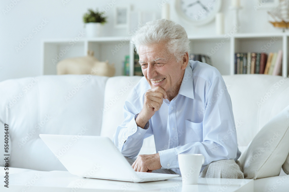 old nice man using laptop at home old nice man using laptop at home