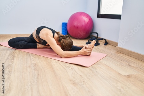 Young woman stretching at sport center