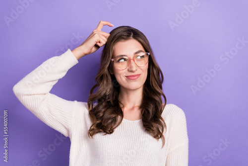 Photo of funky gorgeous smart woman scratch head finger unsure choose best deal option look empty space isolated on purple color background