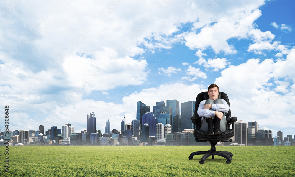 scared businessman on a chair scared businessman on a chair