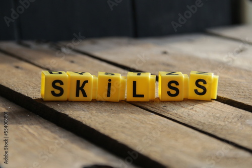 Skills. The inscription from the cubes on a vintage background.