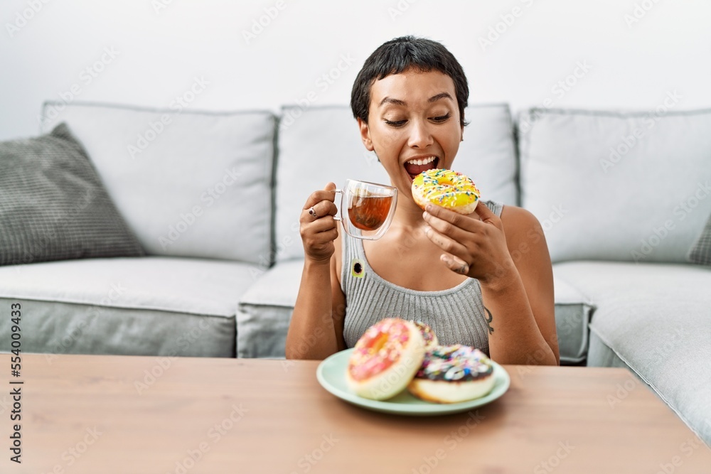 Young hispanic woman smiling confident having breakfast at home Young hispanic woman smiling confident having breakfast at home