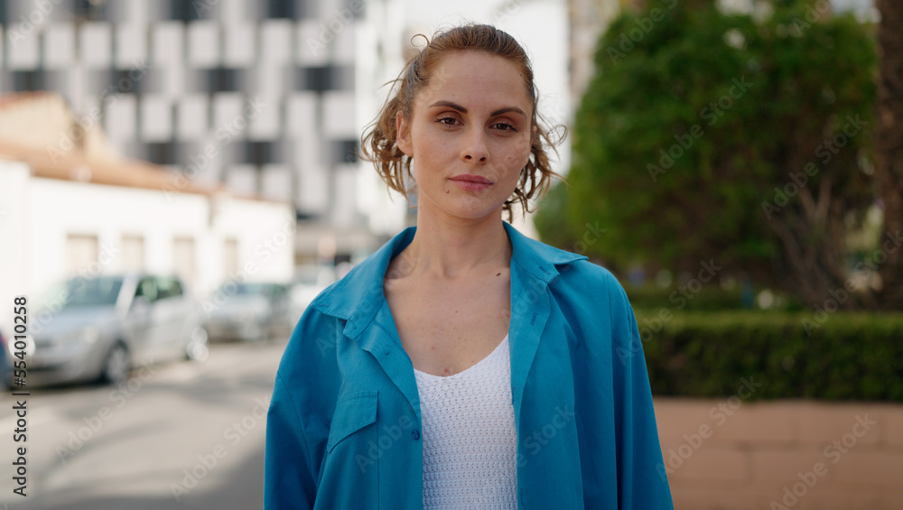 Young woman with relaxed expression standing at street Young woman with relaxed expression standing at street