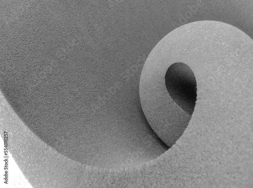 thick gray foam sheet rolled up in spiral style isolated on white background
